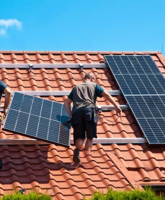 stock-photo-two-men-installing-new-solar-panels-on-the-roof-of-a-private-house-renewable-energy-concept-and-2004938228-transformed